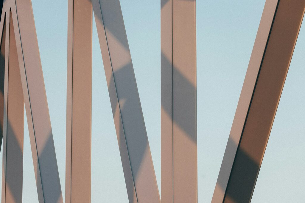 A close up of a metal structure with a blue sky in the background