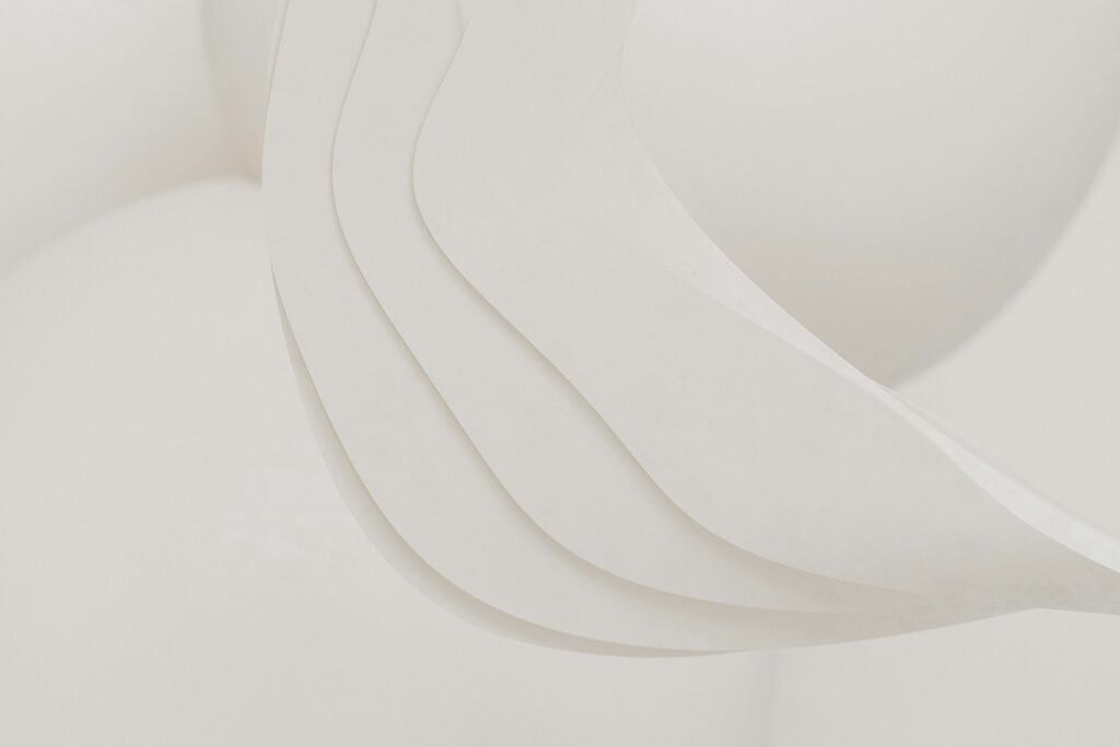 A close up of a white sculpture with curved lines